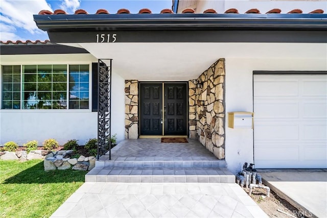 entrance to property featuring stucco siding and stone siding
