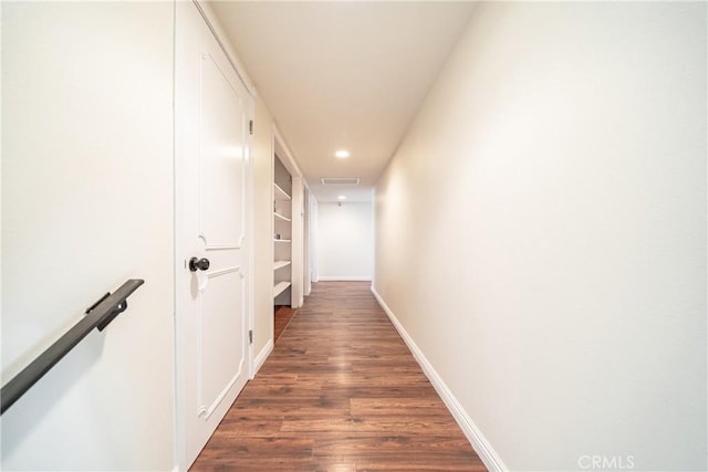 corridor with visible vents, baseboards, recessed lighting, and dark wood-style floors
