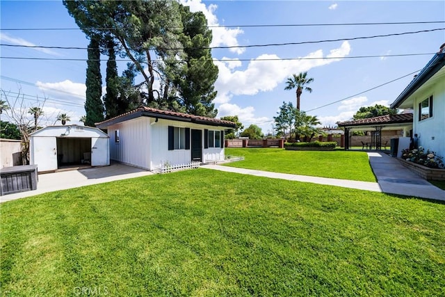 view of yard with an outdoor structure and fence