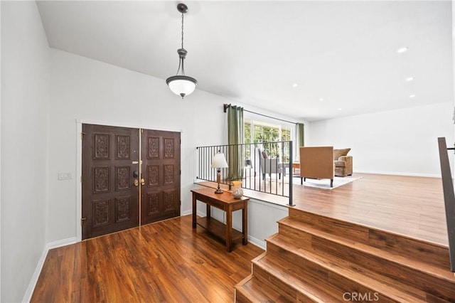 foyer featuring wood finished floors and baseboards
