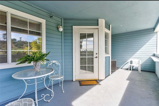 property entrance with covered porch and cooling unit