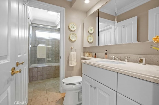 bathroom featuring toilet, ornamental molding, tile patterned floors, and vanity