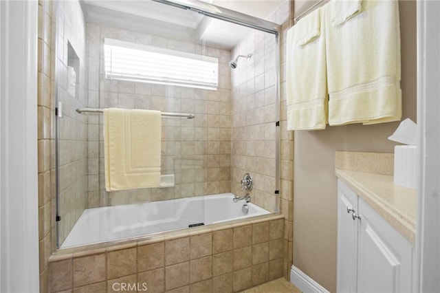 full bathroom with tiled shower / bath combo, tile patterned floors, and vanity