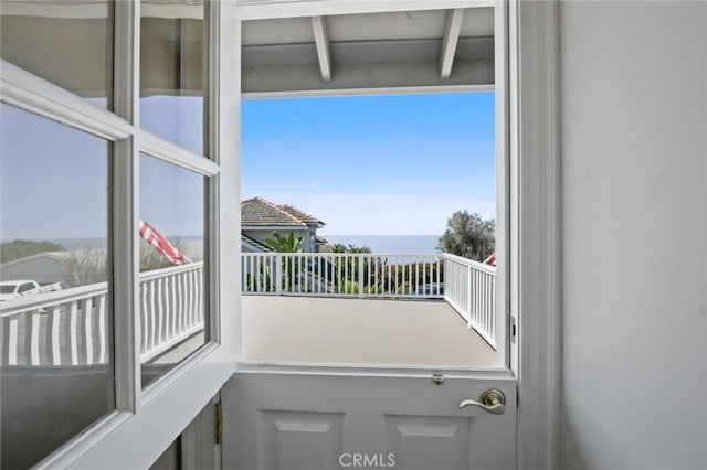 doorway to outside with a water view