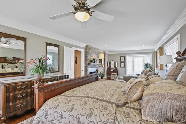 bedroom with crown molding, a ceiling fan, dark wood-style floors, and a fireplace