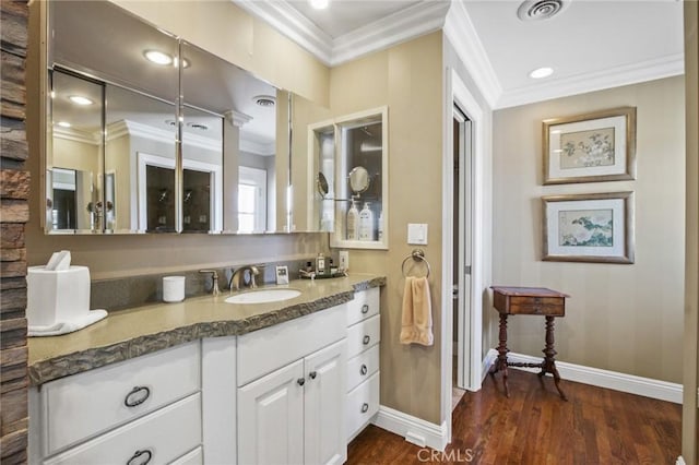 bathroom featuring visible vents, baseboards, ornamental molding, and wood finished floors