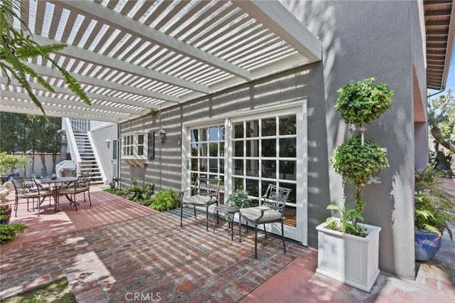 view of patio with a pergola and outdoor dining area