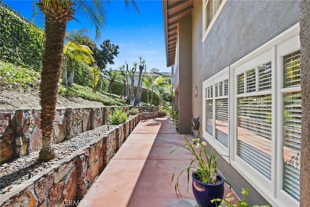 view of side of home featuring a patio area and stucco siding