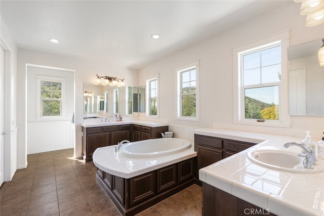 30088 Mauroux Ct, Murrieta, CA 92563 - bathroom featuring two vanities, a sink, recessed lighting, tile patterned flooring, and a garden tub