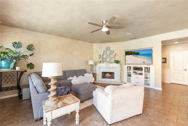 30088 Mauroux Ct, Murrieta, CA 92563 - living room featuring baseboards, visible vents, a lit fireplace, and a ceiling fan
