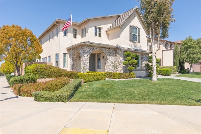 30088 Mauroux Ct, Murrieta, CA 92563 - view of front of house with stucco siding, stone siding, and a front lawn