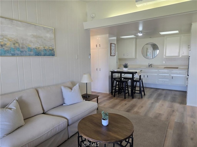 living area featuring wood finished floors and ceiling fan