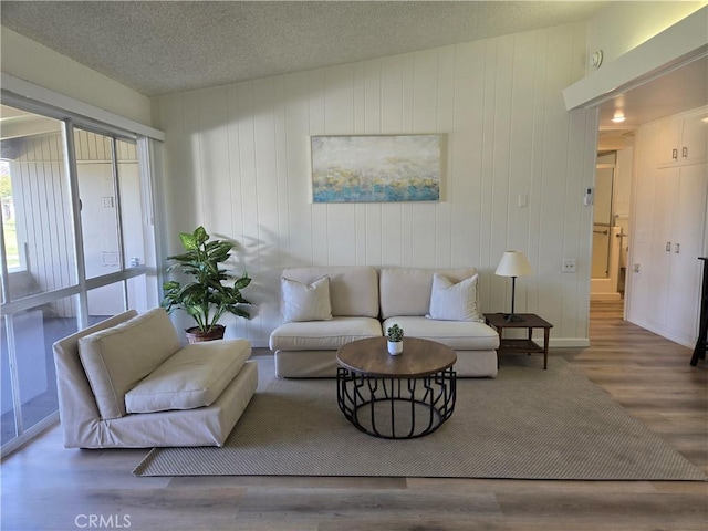 living room with wood finished floors and a textured ceiling