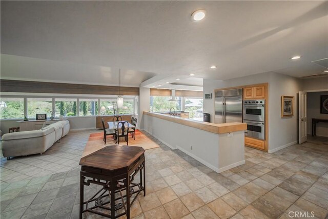 166 Alviso Dr, Camarillo, CA 93010 - kitchen featuring stainless steel appliances, baseboards, light stone finish flooring, recessed lighting, and open floor plan