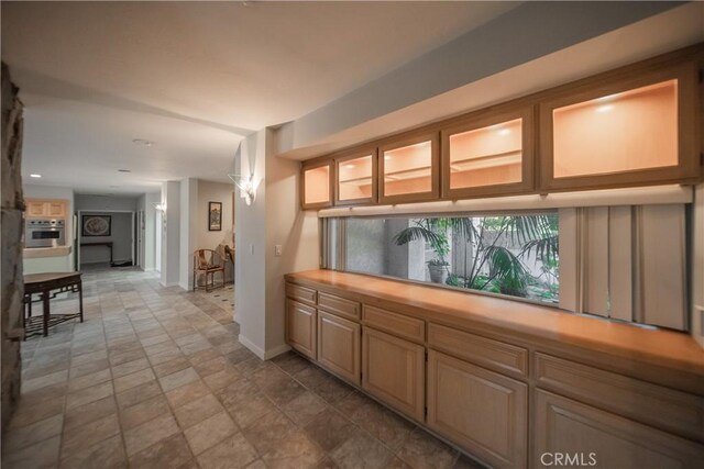 166 Alviso Dr, Camarillo, CA 93010 - bar area featuring oven, baseboards, and stone finish floors