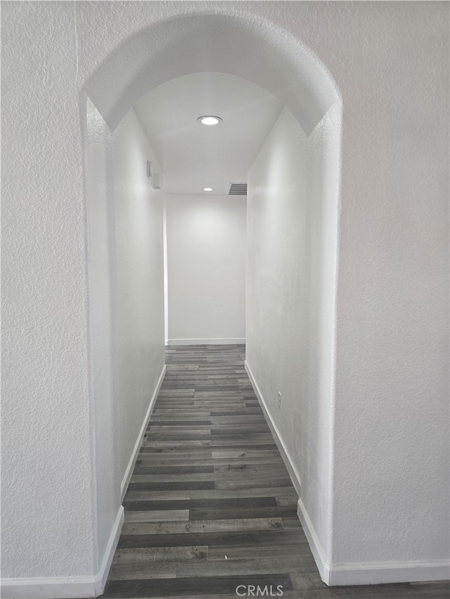37623 Teal St, Palmdale, CA 93552 - hallway with a textured wall, baseboards, dark wood-style floors, recessed lighting, and arched walkways