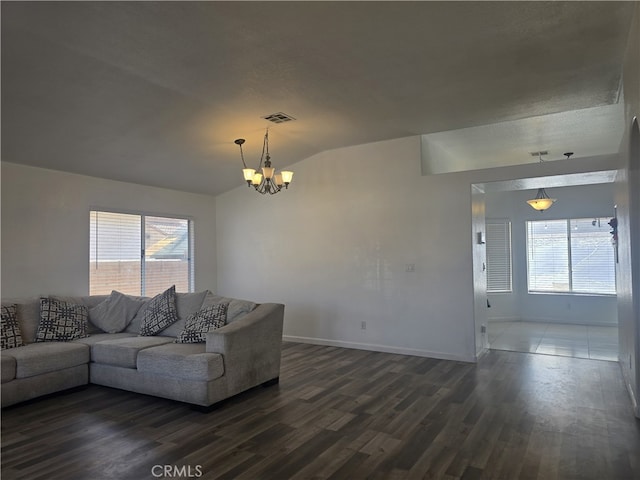 37623 Teal St, Palmdale, CA 93552 - living area with dark wood-style floors, a chandelier, lofted ceiling, plenty of natural light, and baseboards