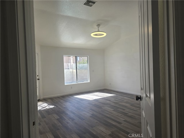 37623 Teal St, Palmdale, CA 93552 - spare room featuring dark wood-style flooring, baseboards, and a textured ceiling