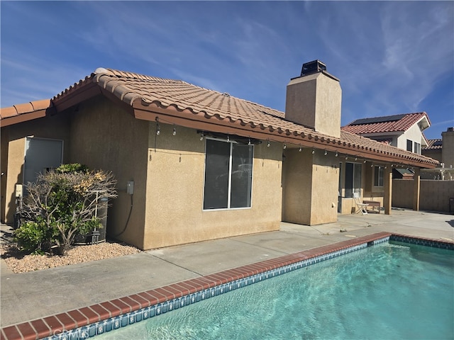 37623 Teal St, Palmdale, CA 93552 - back of house with a patio, a chimney, stucco siding, and a tiled roof
