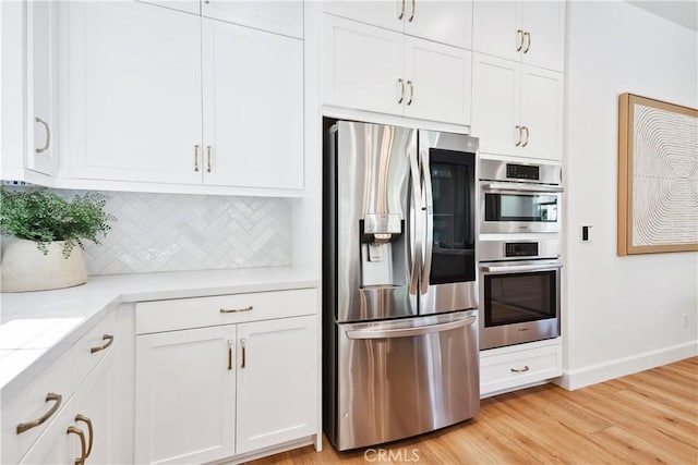 kitchen with light countertops, white cabinets, and stainless steel appliances