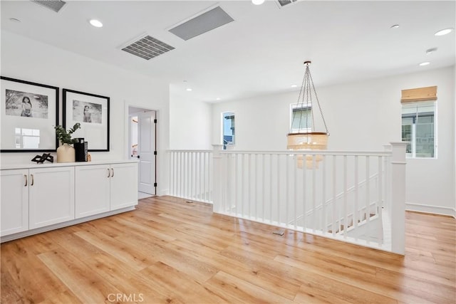 unfurnished room with visible vents, light wood finished floors, and recessed lighting