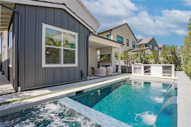 view of swimming pool with a fenced in pool, a patio, and an outdoor fireplace