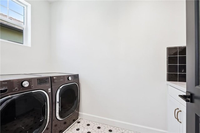 laundry area with washer and dryer, baseboards, light floors, and cabinet space