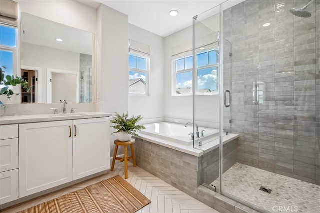 full bath with a shower stall, a bath, vanity, and recessed lighting