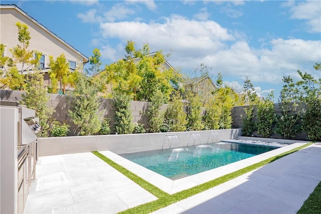 outdoor pool with a fenced backyard and a patio
