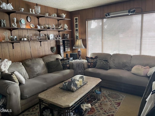 living area featuring a textured ceiling, wood walls, carpet flooring, and a wealth of natural light