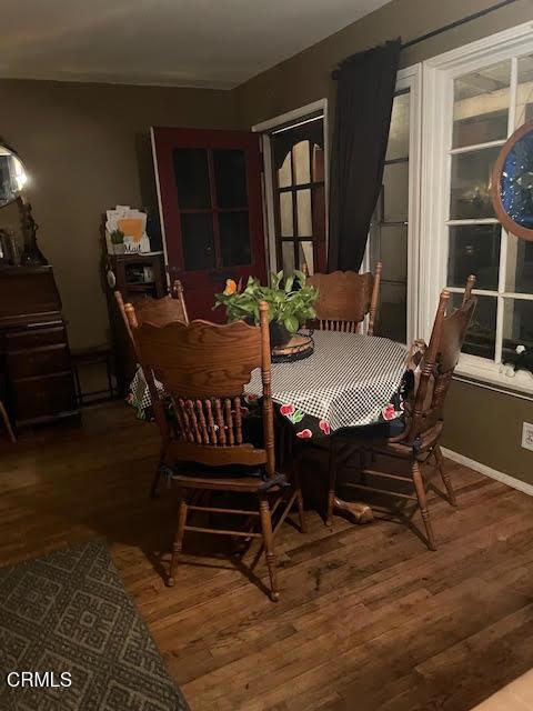 dining space with wood finished floors
