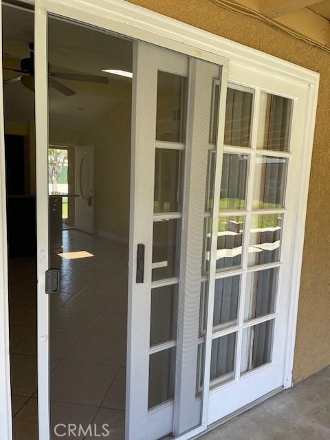 doorway to property featuring stucco siding