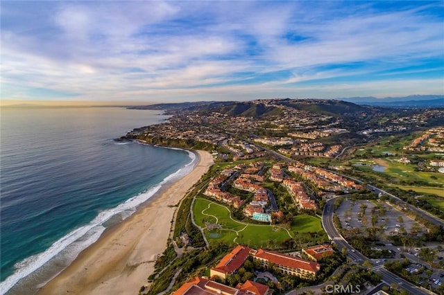 birds eye view of property with a water view and a view of the beach