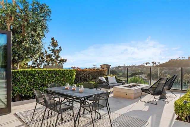view of patio / terrace with a fire pit and outdoor dining area