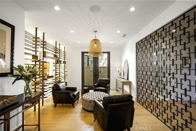 sitting room with recessed lighting, light wood-style flooring, visible vents, and french doors