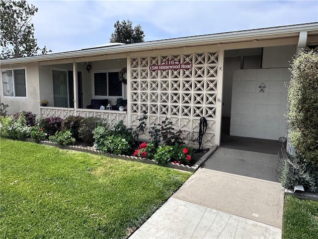 property entrance with a yard and a porch