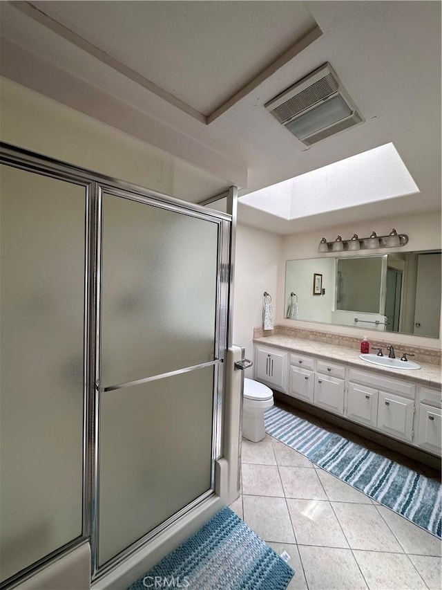 full bathroom featuring visible vents, a shower stall, tile patterned flooring, and vanity