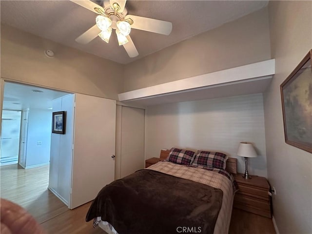 bedroom with wood finished floors, ceiling fan, and baseboards