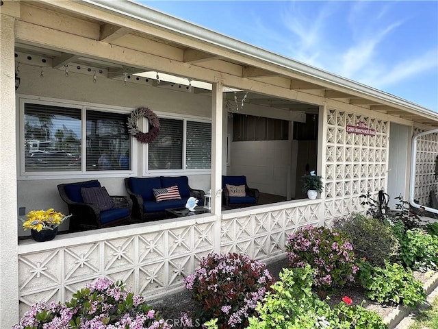 entrance to property featuring outdoor lounge area and stucco siding