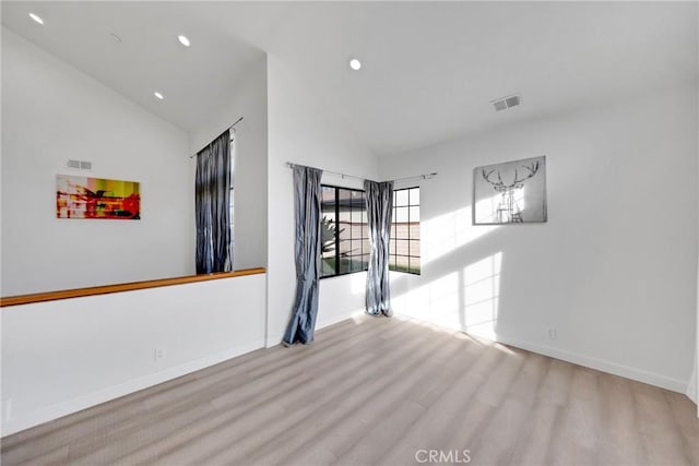 unfurnished room with recessed lighting, visible vents, wood finished floors, and high vaulted ceiling