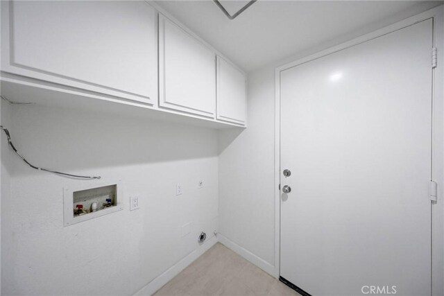 laundry room with baseboards, washer hookup, and cabinet space