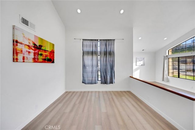 spare room featuring visible vents, baseboards, lofted ceiling, and recessed lighting