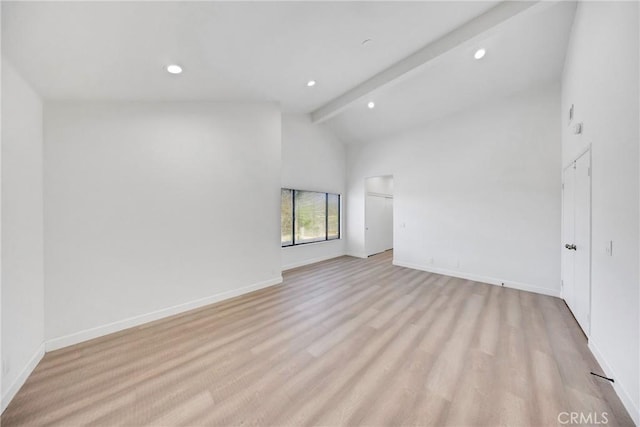unfurnished room with light wood finished floors, baseboards, lofted ceiling with beams, and recessed lighting