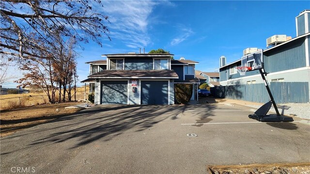 20211 Carlisle Rd, Apple Valley, CA 92307 - view of front facade featuring an attached garage and a residential view