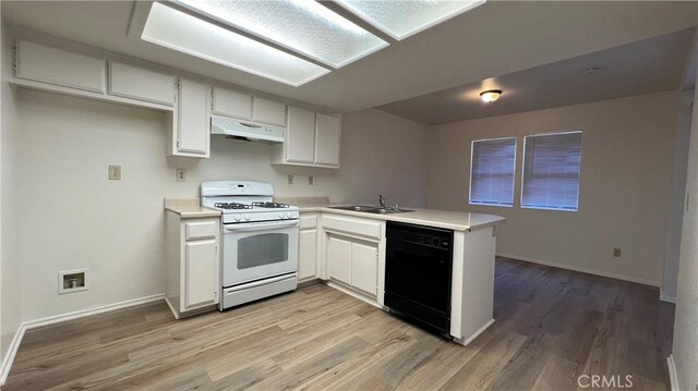 20211 Carlisle Rd, Apple Valley, CA 92307 - kitchen featuring white gas range oven, black dishwasher, under cabinet range hood, a peninsula, and a sink