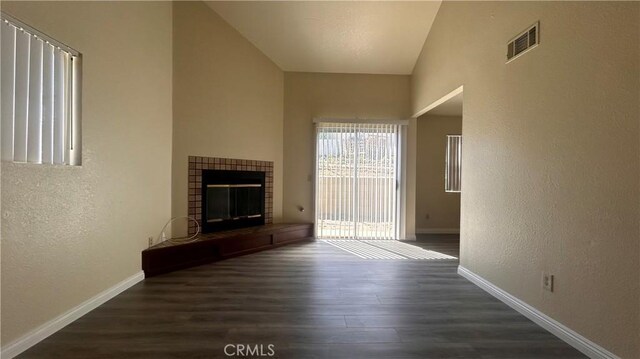 20211 Carlisle Rd, Apple Valley, CA 92307 - unfurnished living room featuring wood finished floors, a textured wall, a tile fireplace, and baseboards