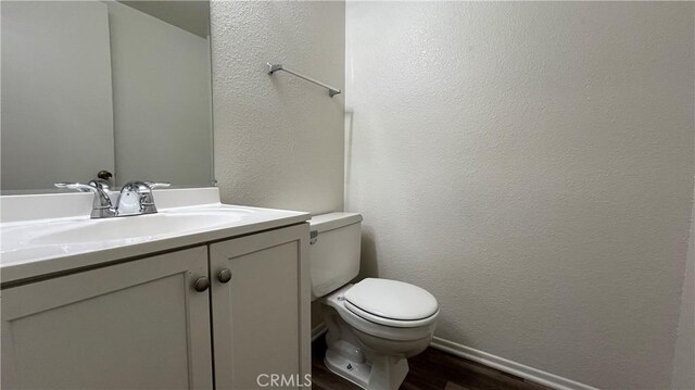 20211 Carlisle Rd, Apple Valley, CA 92307 - bathroom with toilet, wood finished floors, vanity, a textured wall, and baseboards