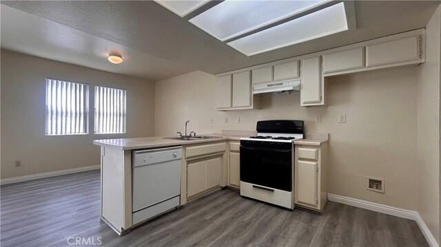 20211 Carlisle Rd, Apple Valley, CA 92307 - kitchen featuring white appliances, under cabinet range hood, a peninsula, light countertops, and a sink