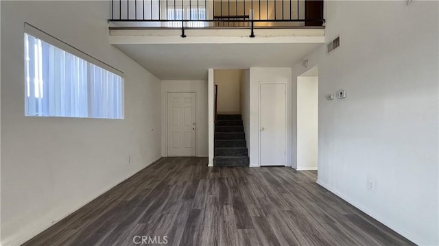 20211 Carlisle Rd, Apple Valley, CA 92307 - unfurnished living room featuring stairway, dark wood-type flooring, and baseboards