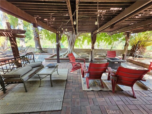 view of patio / terrace featuring a pergola, a fire pit, and fence